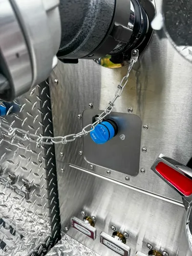Pump-service compartment close-up with pressure gauge and pipework.